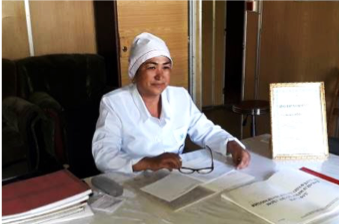 Gulmira Abduqodirova, Director of the Lyakhsh District TB Center, proudly displays the certificate recognizing her as the best TB nurse in Tajikistan.