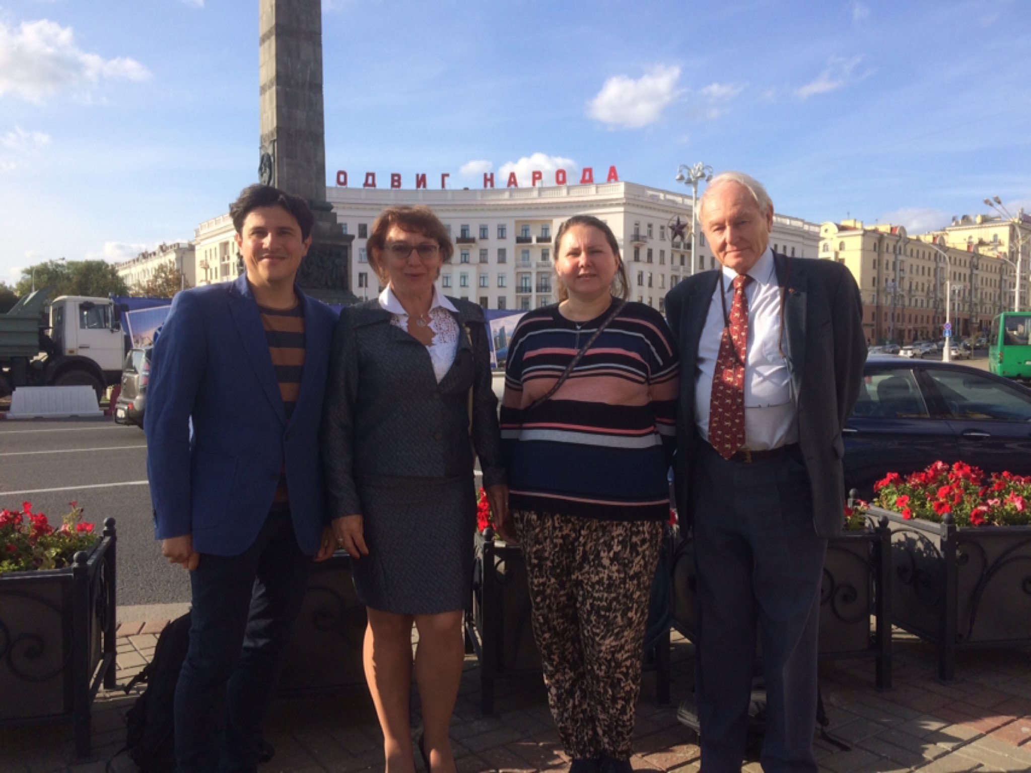 Daniel Kasnitsky (TBEC Capacity Building Manager), Paul Sommerfeld (TBEC Board Member) stand with two participants outside during the National Dialogue in Belarus
